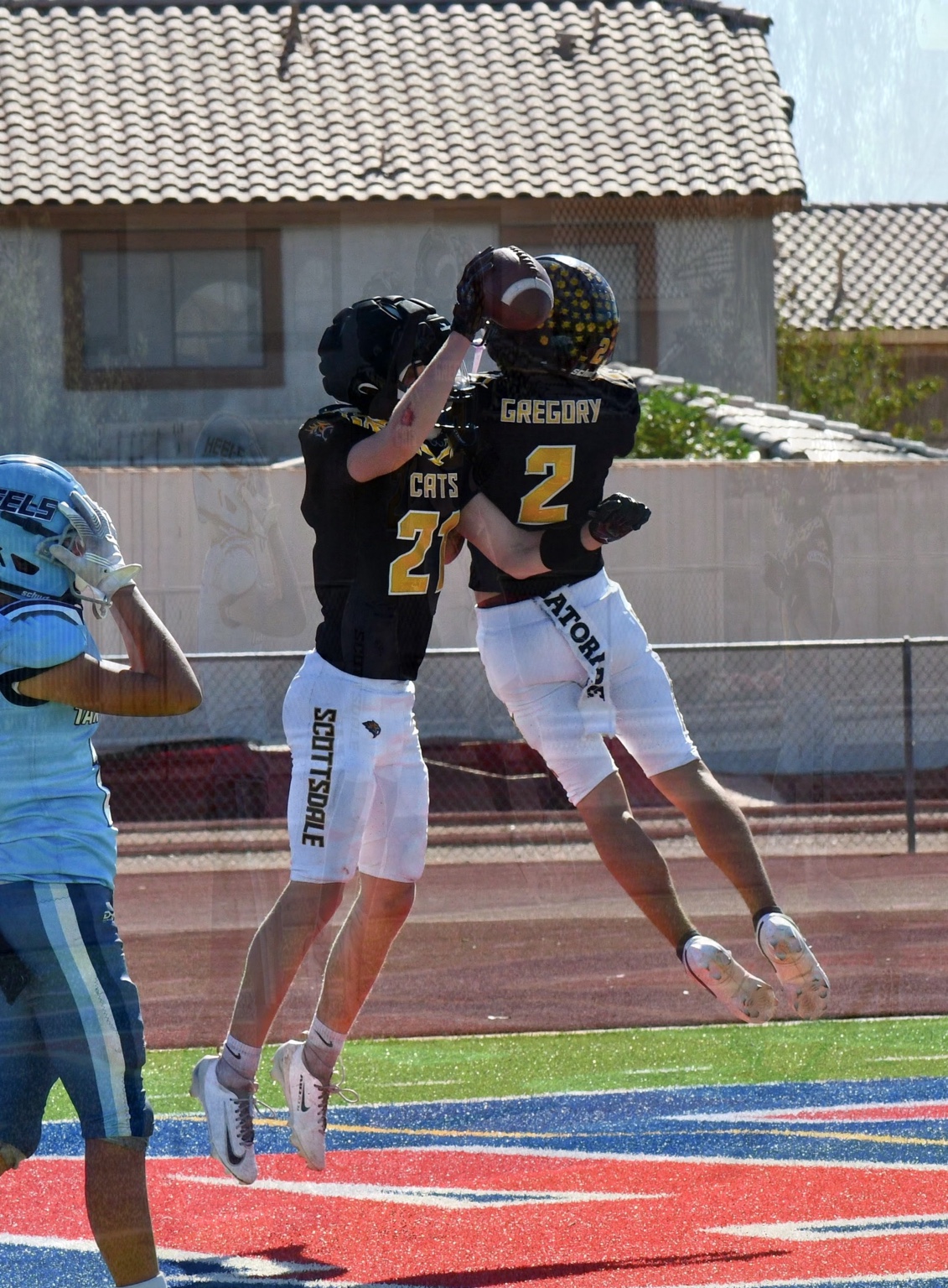 Two Sabercats players celebrating together on the field